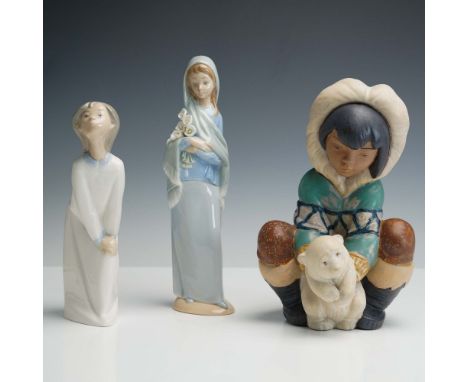 A charming trio of  porcelain figurines including Poor Little Bear 1012232 shown wearing a fur lined parka and seated with a 