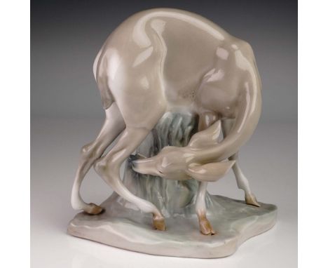 This early and very rare Lladro porcelain figurine features a stylized gazelle bending down to graze, its elongated form and 