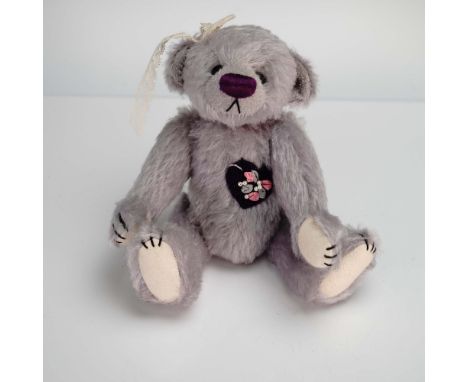 This charming Deb Canham artist-designed bear named Violet is a delightful collectible, handmade in a limited edition of just
