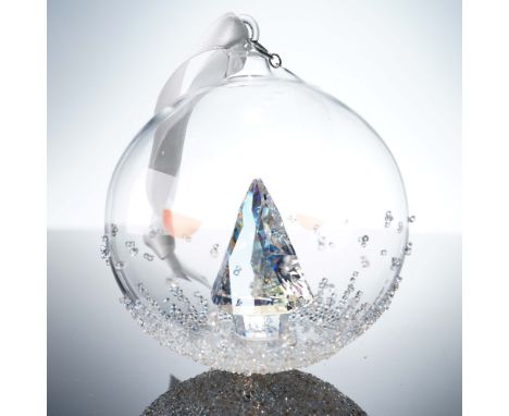 Annual edition Christmas ball featuring a dazzling clear crystal Christmas tree set within a hand-blown glass globe. Accented