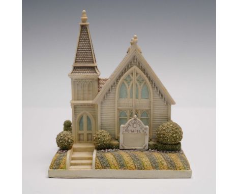 A charming architectural collectible that captures the romantic spirit of a traditional ceremony. Modeled in resin with fine 