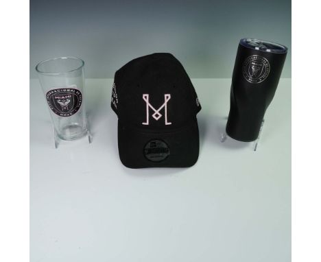 A group of three Inter Miami CF fan memorabilia including an adjustable New Era hat with pink stitched M monogram on the fron
