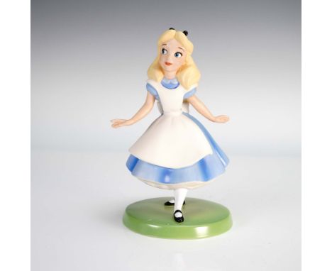 This sculpture depicts Alice mid-step in her iconic blue dress with white apron and black hair ribbon, standing on a circular