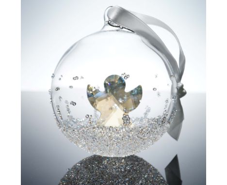 This limited edition 2015 Swarovski Christmas Ornament features a stunning faceted crystal angel encased within a clear glass