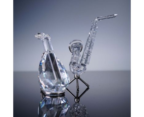 Two Swarovski Silver Crystal musical instrument figurines from the "Crystal Melodies" collection. Includes one clear crystal 