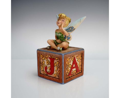 From the Disney Traditions collection by Jim Shore, this charming hand-painted figurine features Tinker Bell in a playful pos