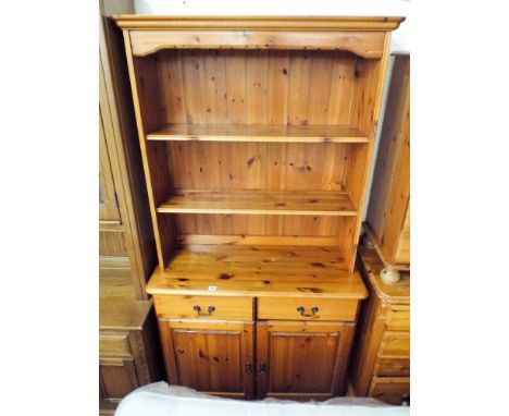 A modern pine kitchen dresser with open shelf back, drawers and cupboards under 3' wide 