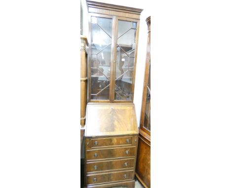 A four drawer glazed bureau bookcase standing on bracket feet with a fitted interior 2 metres high 57cms wide 