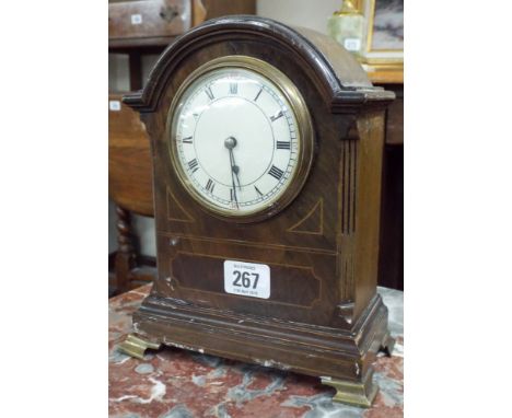 A mahogany and walnut inlaid mantle clock standing on brass feet with painted Roman numeral dial overall height 23cms 