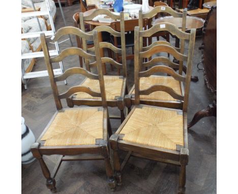 A set of four oak ladder back dinning chairs with rush seats 