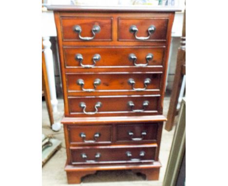 A miniature yew wood reproduction chest on chest of eight drawers with swan neck handles and standing on bracket feet, 76cms 