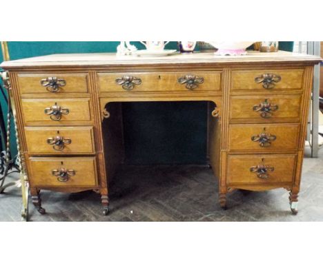 A Victorian light oak pedestal desk fitted four drawers to each pedestal with decorative Art Nouveau brass pressed handles 