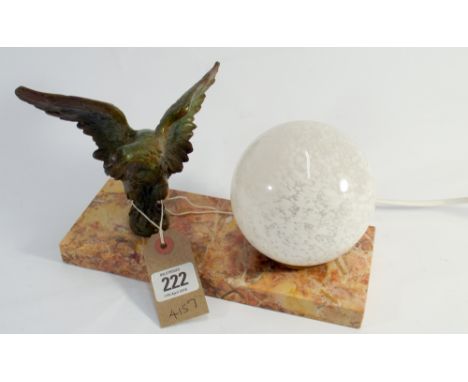 An art Deco, French lamp, consisting of a spelter eagle and glass sphere standing on a rectangular marble plinth 