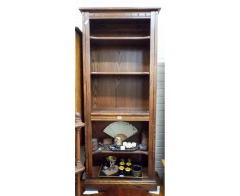 An Ercol oak bookcase of four shelves approx 150cms high 60cms wide 