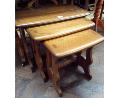 A nest of three elm Ercol coffee tables 