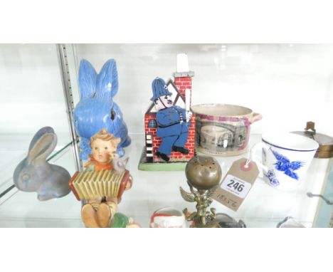 A selection of items including: a wooden money box in the shape of a house and policeman, two blue Sylvac rabbits and a small