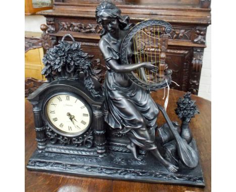 A reproduction French style quartz mantle clock decorated with a lady figure playing harp 