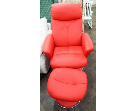 A modern revolving reclining chair in red faux leather with matching stool