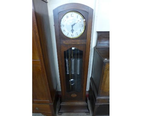 A 1930's Enfield oak triple weight longcase clock