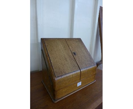 An Edward VII oak table top stationery cabinet with fitted interior