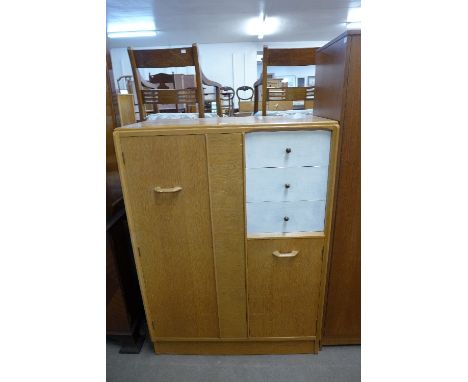 An E. Gomme G-Plan light oak tallboy