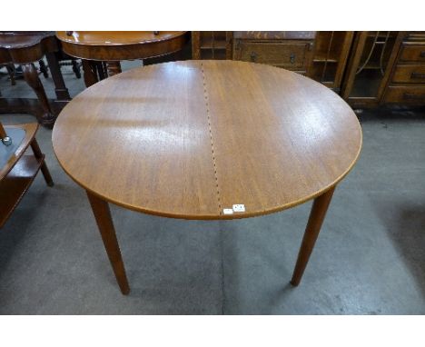 A Danish teak circular extending dining table