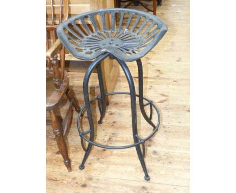 Cast tractor seat converted to bar stool