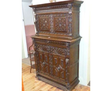 Victorian carved oak side cabinet having two carved panel doors enclosing fitted interior above a long drawer with two carved