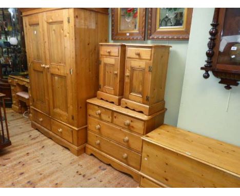 Nine piece pine bedroom suite comprising double door combination wardrobe, pedestal dressing table, stool, four drawer chest,