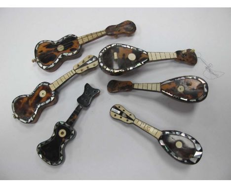 Miniature Tortoiseshell Mandolins/Guitars, with mother of pearl insets, the longest 15cm (6)