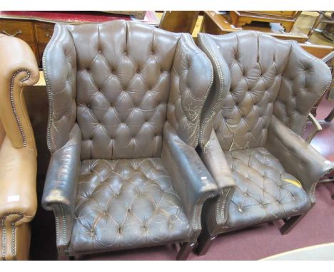 Pair of Brown Leather Button Back Wing Armchairs, with studded decoration, on straight legs. (2)