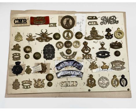 South Africa. A display card containing cap badges, collar dogs, shoulder titles and buttons. Includes: Cape Mounted Rifles, 