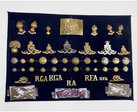 Royal Artillery. A display card containing cap badges, collar dogs, shoulder titles and buttons. Noted: Various versions of R