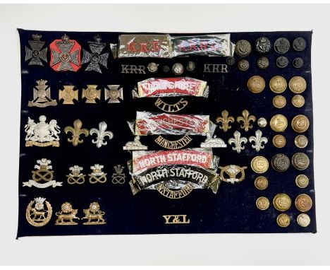 English Regiments. A display card containing cap badges, collar dogs, shoulder titles and buttons. Noted: Kings Royal Rifles,
