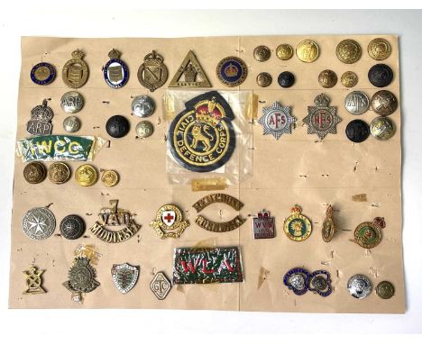 Military Auxiliary Services. A display card of badges, buttons, etc. Noted: On War Service, On War Service 1915, War Munition