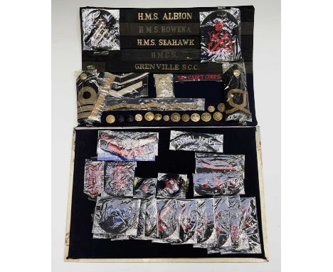Royal Navy - 1. Two display cards containing various cloth shoulder titles, ship hat bands, buttons, etc. Hat Bands include H