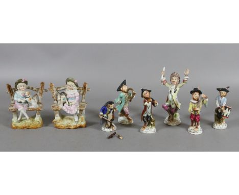 A collection of Continental porcelain figurines to include six members of the monkey band and two seated bisque figurines wit