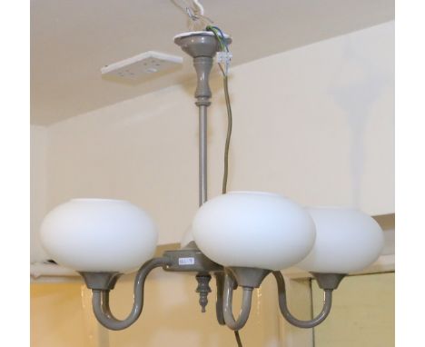 A five branch ceiling light with opaque glass shades.
