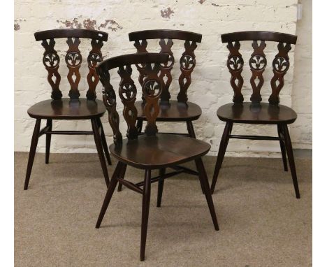 Four Ercol dining chairs with Prince of Wales feathers motif.