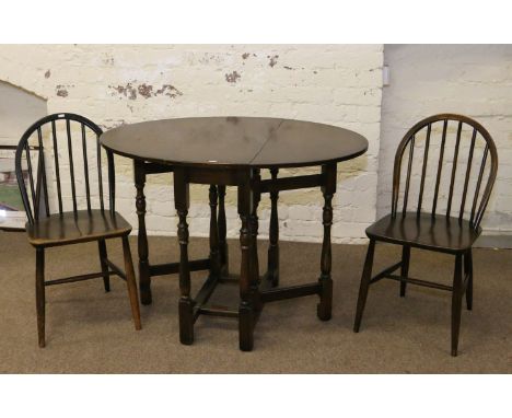 An oak gateleg table and a pair of Ercol style dining chairs.