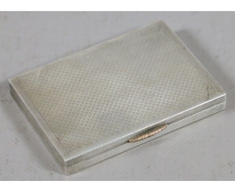 A silver compact case with engine turned engraving and gilded interior, assayed Birmingham 1936, 98.4 grams.