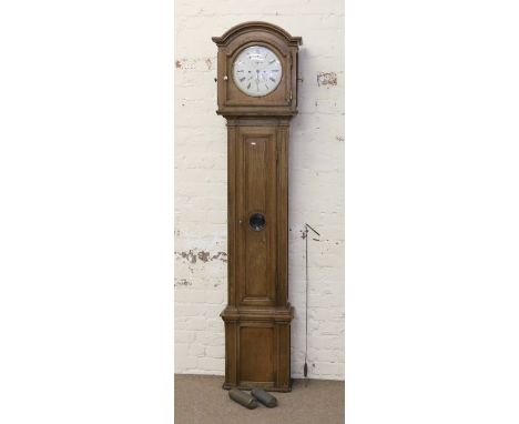 A C19th continental oak cased eight day longcase clock with circular enamel dial having three subsidiary dials.