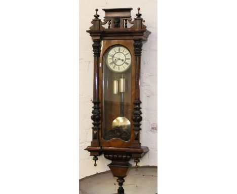 A C19th walnut cased twin weight Vienna wall clock.