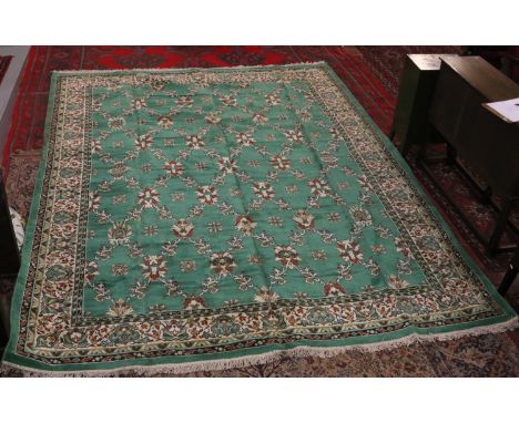 A large green ground Belgian carpet measuring 11' x 6" x 8' x 6".