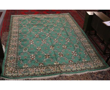 A large green ground Belgian carpet measuring 11' x 6" x 8' x 6".