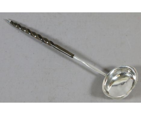 A C19th white metal toddy ladle with whale bone handle.