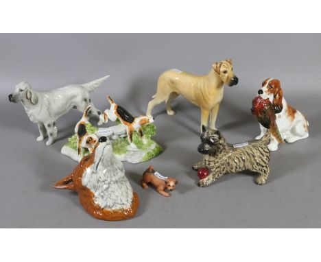 A collection of pottery model dogs to include Royal Doulton and Goebel examples along with a Derby fox mask.