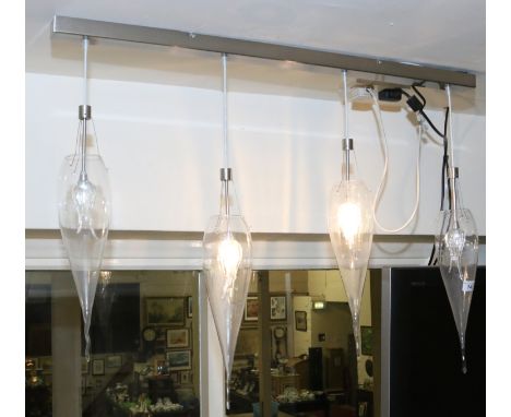 An unusual stainless steel light fitting with four conical shaped clear glass shades.