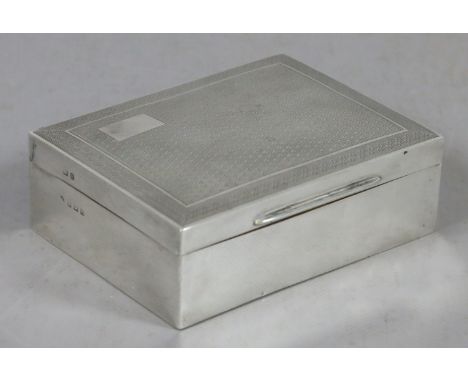 A silver cigarette box with engine turned engraving, assayed Birmingham 1929.