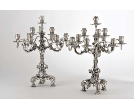 A pair of ten-light candelabra, 916/1000 silver, decoration en relief "Flowers and plant windings", Portuguese, missing a can